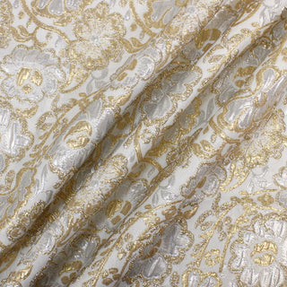 three diagonal lines draped of a silver and gold floral jacquard woven fabric