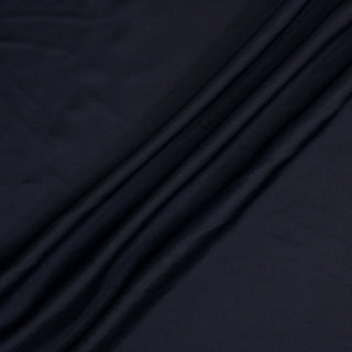 three draped diagonal lines of a midnight blue colored silk mikado fabric
