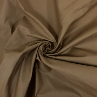 Swirl of a milk chocolate canvas, detailing the surface shine and drape.