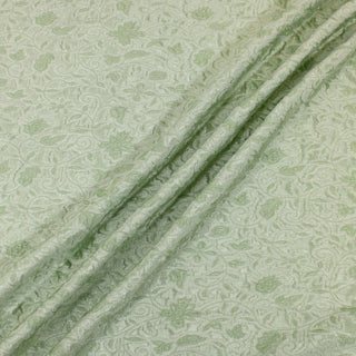 Three lines draped of a mint green brocade fabric.