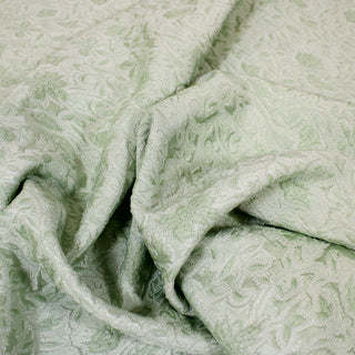 Close up of a mint green brocade, detailing the surface shine.