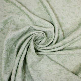 Swirl of a mint green brocade, detailing the surface shine and drape.