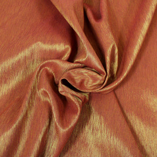Close up of an orange and gold faille fabric, detailing the surface shine.