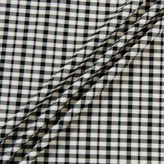 Three lines draped of a pink black plaid fabric.