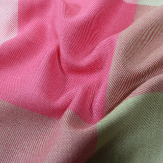closeup of a pink multi plaid flannel, detailing the surface shine and drape.