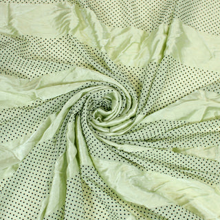 Swirl of a pistachio green satin fabric, detailing the drape and surface shine.