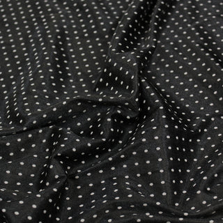 Close up of a polka dot jacquard fabric, detailing the surface shine and drape.