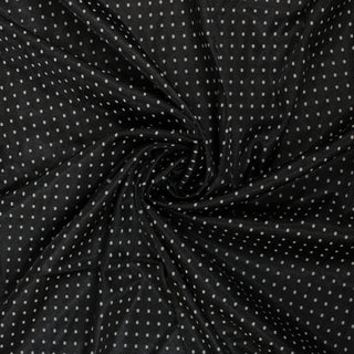 Swirl of a polka dot jacquard fabric, detailing the surface shine and drape.
