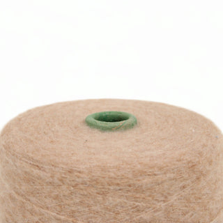 Closeup of praline wool yarn on a white background.