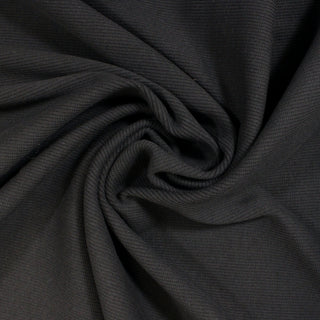 swirl of a grey rib knit jersey fabric, demonstrating the drape and shine of the fabric