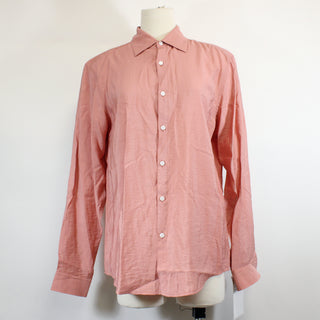 salmon colored button-up mens shirt on a white background