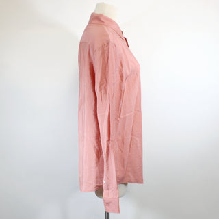 salmon colored long-sleeve shirt on a mannequin, posed at a side view against a white background
