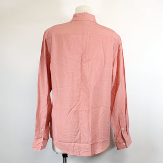 back view of a salmon colored button up shirt on a mannequin against a white background