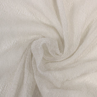 swirl of a sparkly novelty organza fabric, demonstrating the drape and shine of the fabric