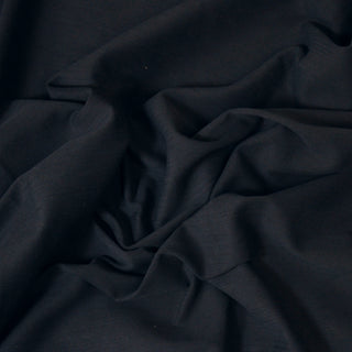 Close up of a navy twill fabric, detailing the drape.