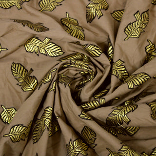 Swirl of a brown plain weave fabric with brocade feather embroidery, detailing the drape and surface shine.