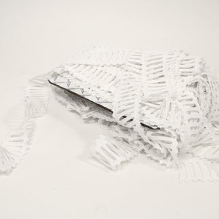 large pile of white ladder trim on a white background