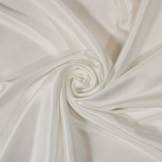 Swirl of a white charmeuse fabric, detailing the surface shine and drape.