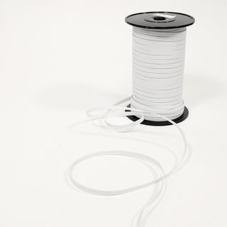 Spool of white elastic on a white background