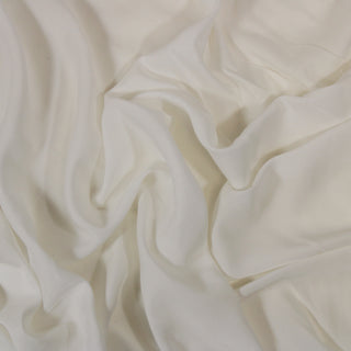Close up of a white voile, detailing the surface shine and drape.