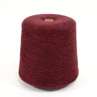 Cone of red wool yarn on a white background.