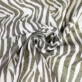 swirl of a lurex zebra jacquard fabric, demonstrating the drape and shine of the fabric.